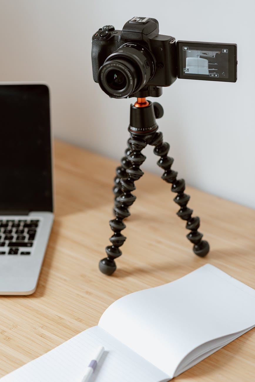 camera on tripod recording video on table